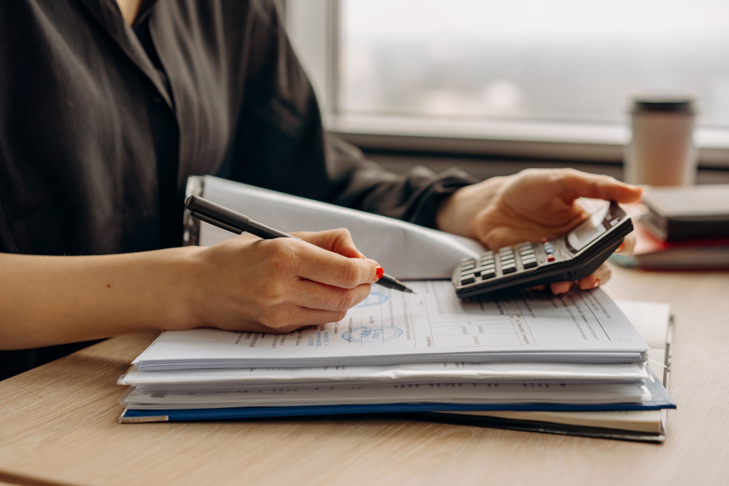Payroll and bookkeeping records arranged on a desk